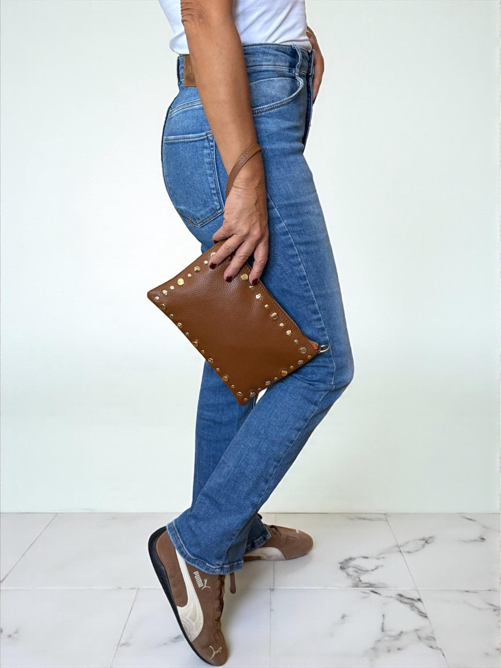 Clutch de piel granulada marrón oscuro con ribete dorado y tachuelas -