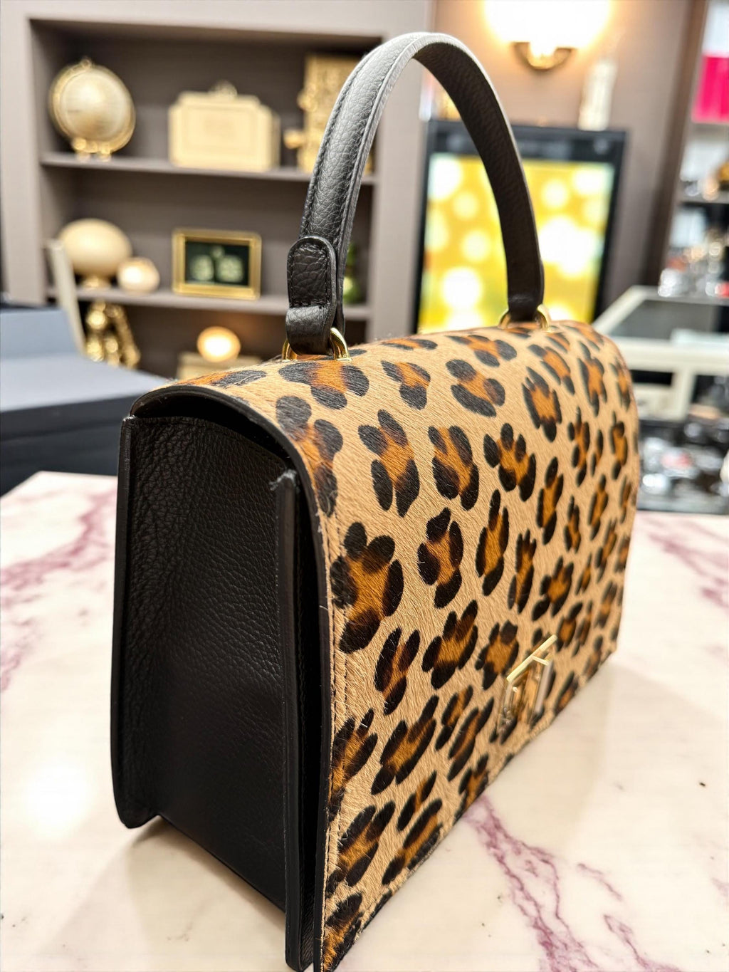 Bolso tipo cartera en pelo de poni con estampado de leopardo y cuero granulado auténtico