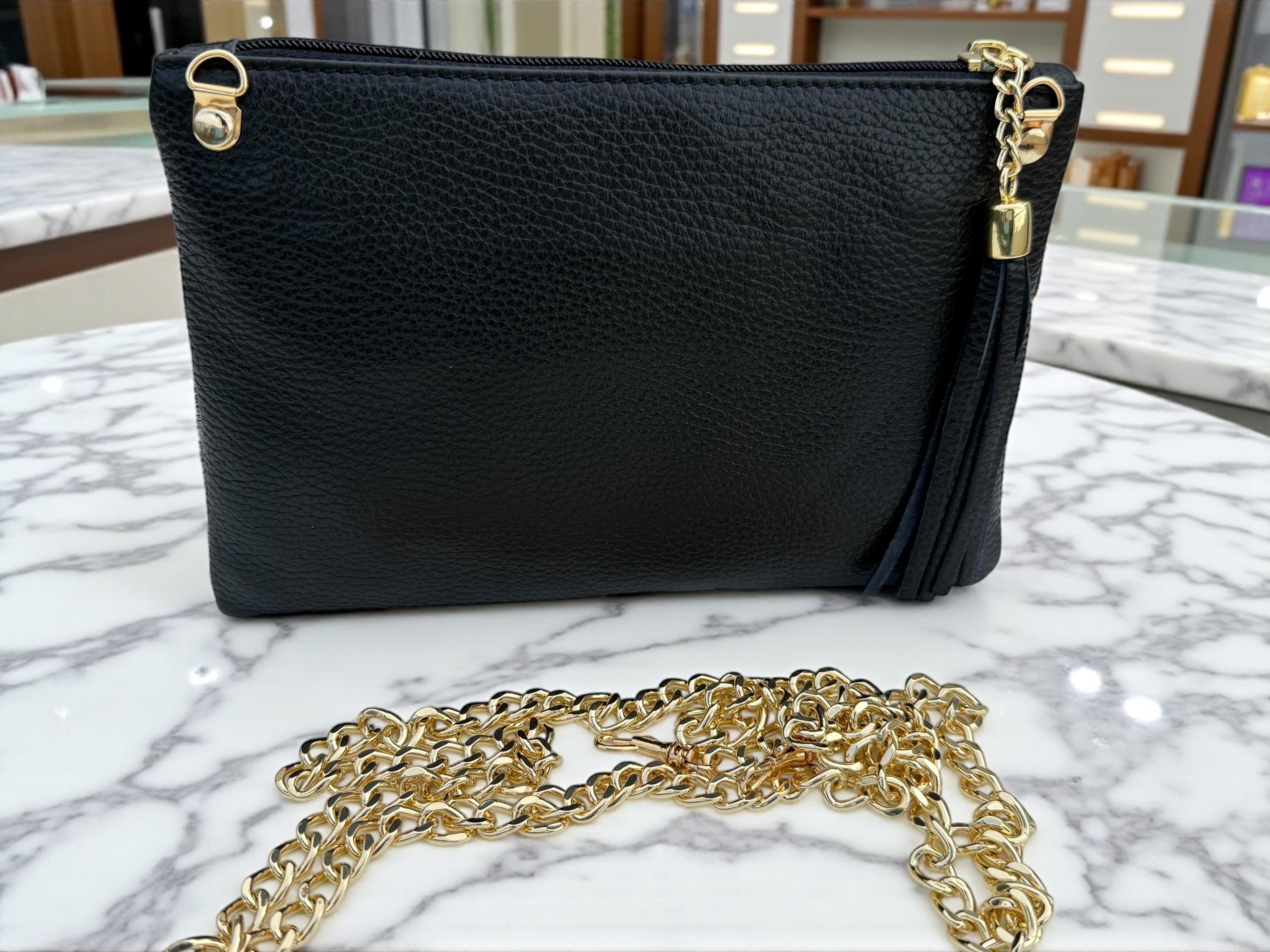 Clutch de piel de poni con estampado de pata de gallo, cadena dorada y borla